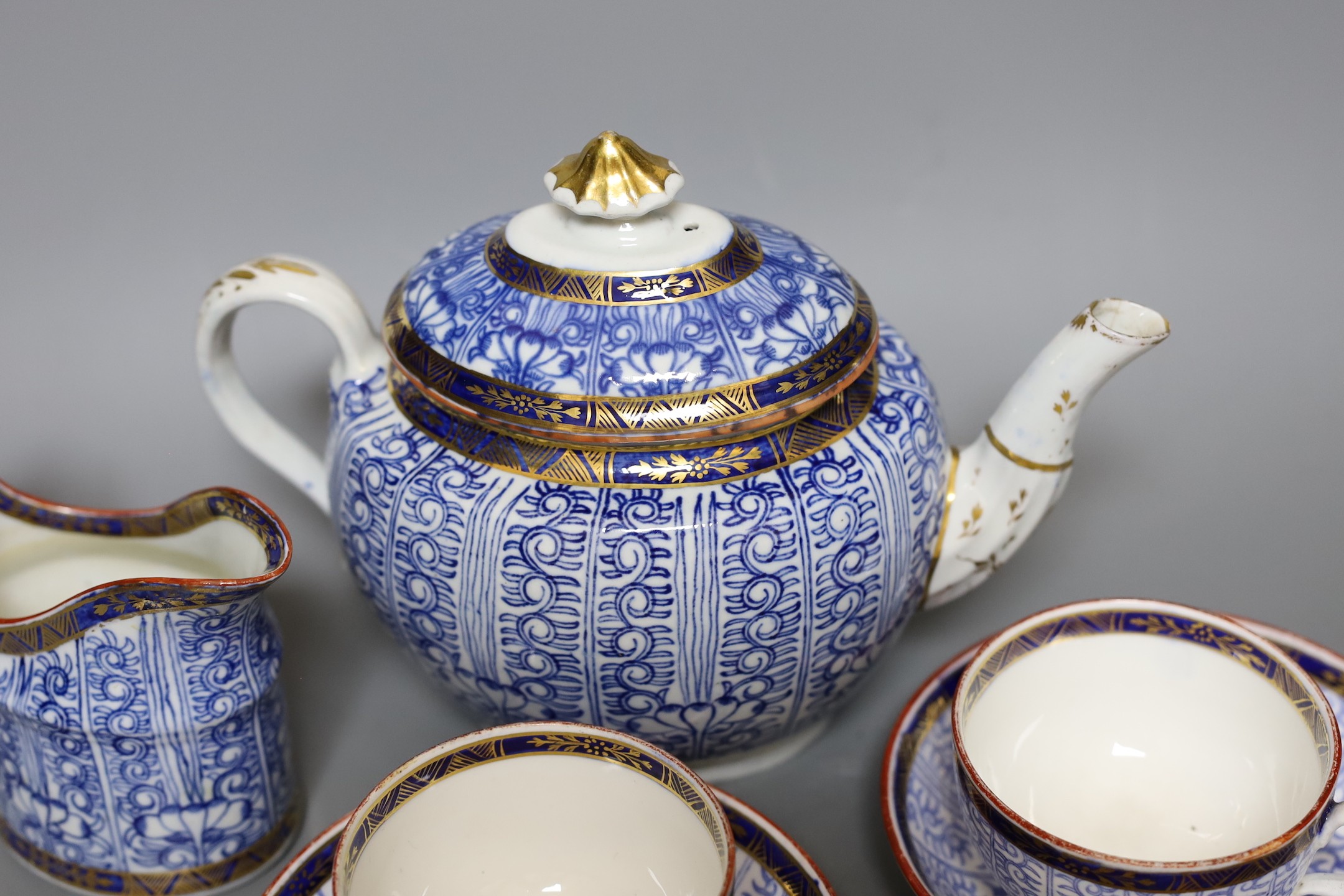 Two Worcester Royal Lily cups and saucers, a cream jug and a teapot- 18 cms high including lid